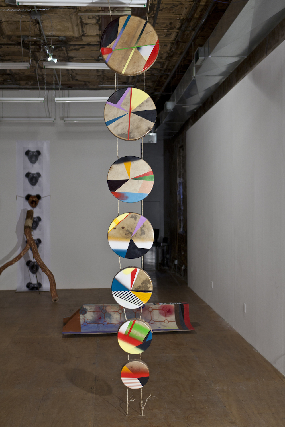 Jeffrey Gibson, *Drum Column*, completed 2012. Acrylic paint, elk hide drums made by Jess McMann-Sparvier, rawhide lacing, artificial sinew. Photo: Etienne Frossard