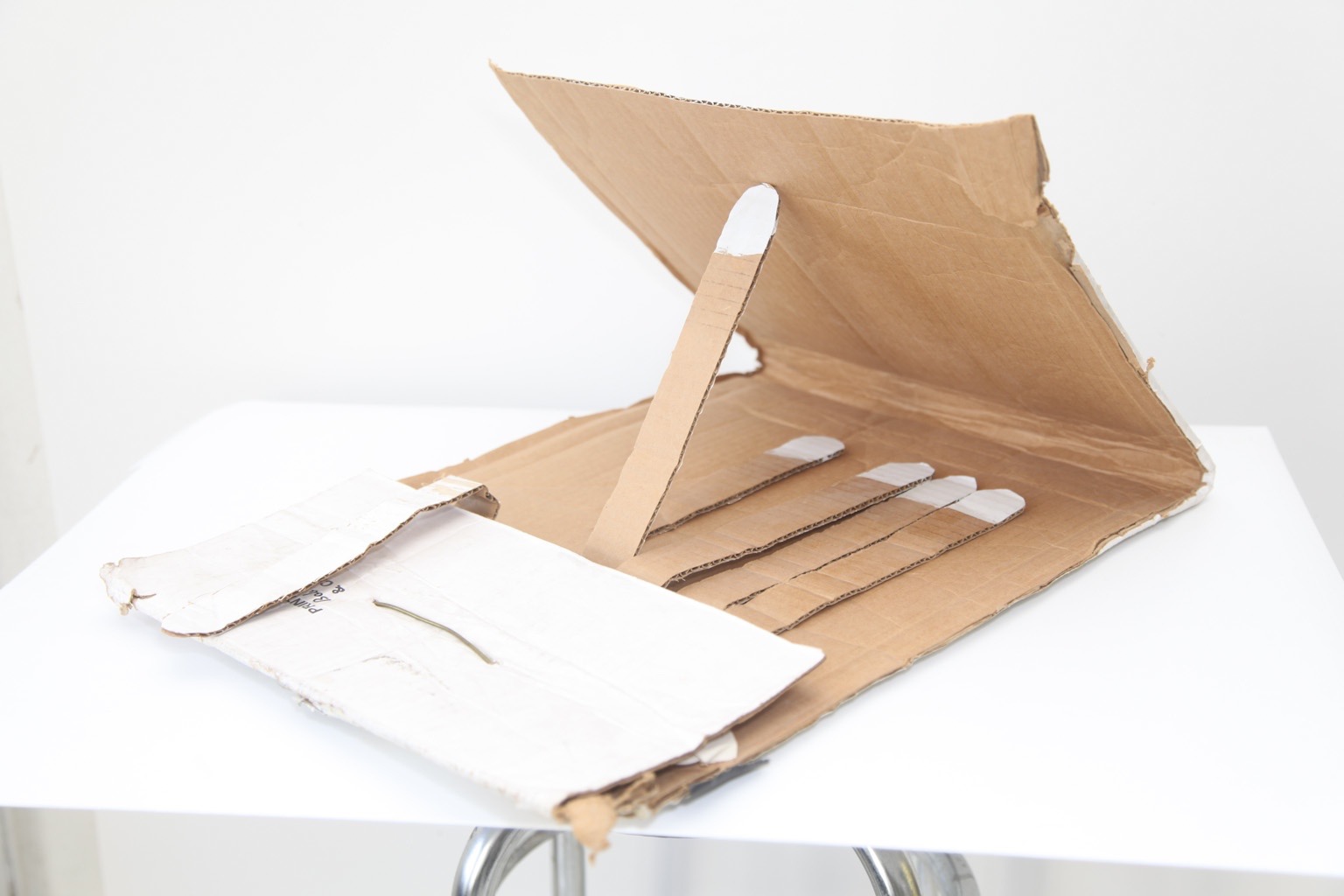 T De Long, *Matches*, 2007. Cardboard, coat hanger, acrylic paint, gaffer tape