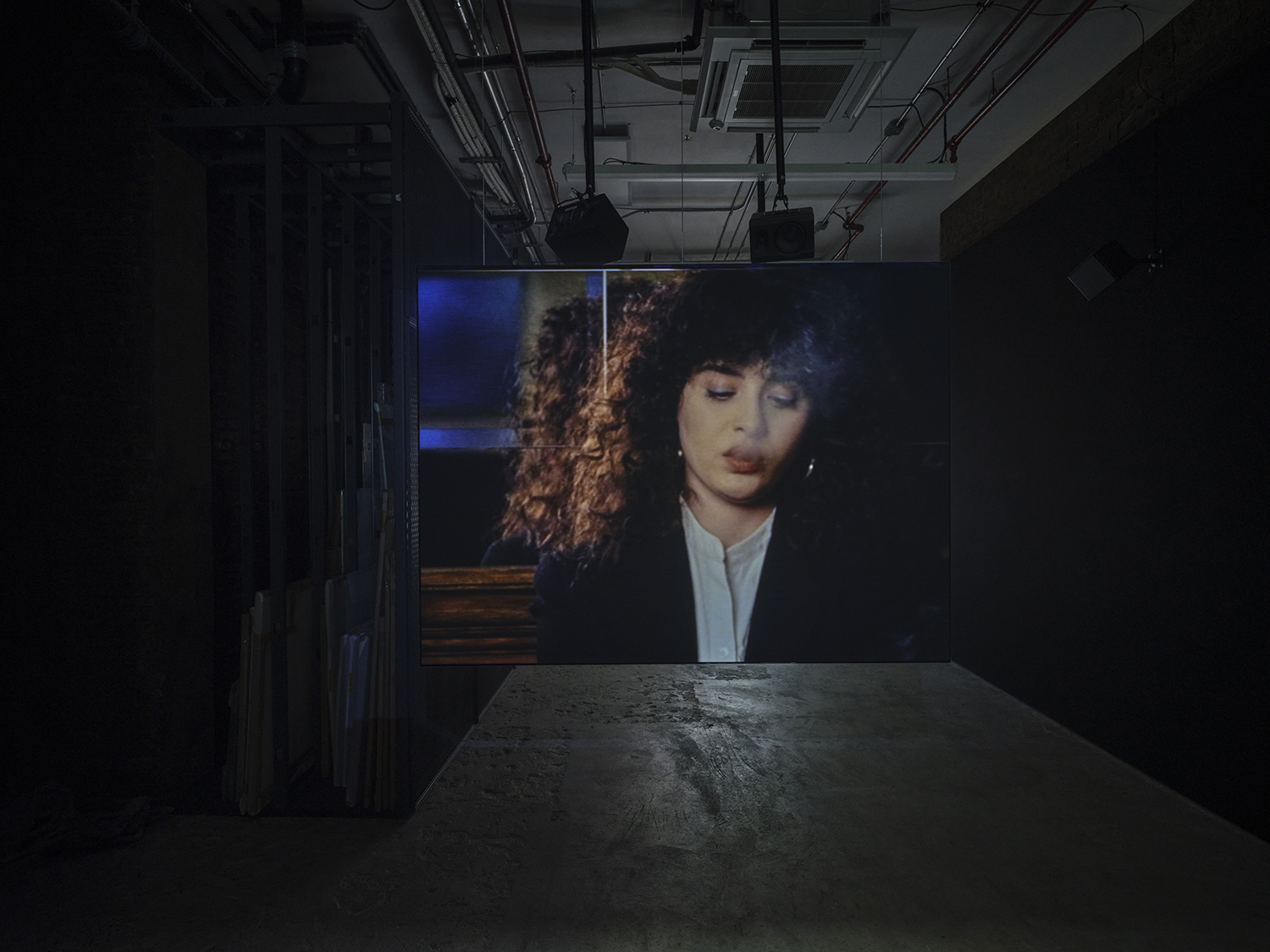 Elisabeth Subrin, *The Listening Takes / Manal Issa, 2024*, 2024, installation view; pictured *The Listening Takes*, 2023-2024, <br>30:00 minutes, 3-channel 16mm/HD video, 9-channel sound, speakers, suspended screens, Photo: Daniel Kukla