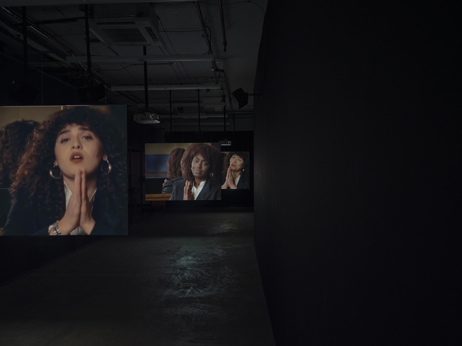 Elisabeth Subrin, *The Listening Takes / Manal Issa, 2024*, 2024, installation view; pictured *The Listening Takes*, 2023-2024, <br>30:00 minutes, 3-channel 16mm/HD video, 9-channel sound, speakers, suspended screens, Photo: Daniel Kukla