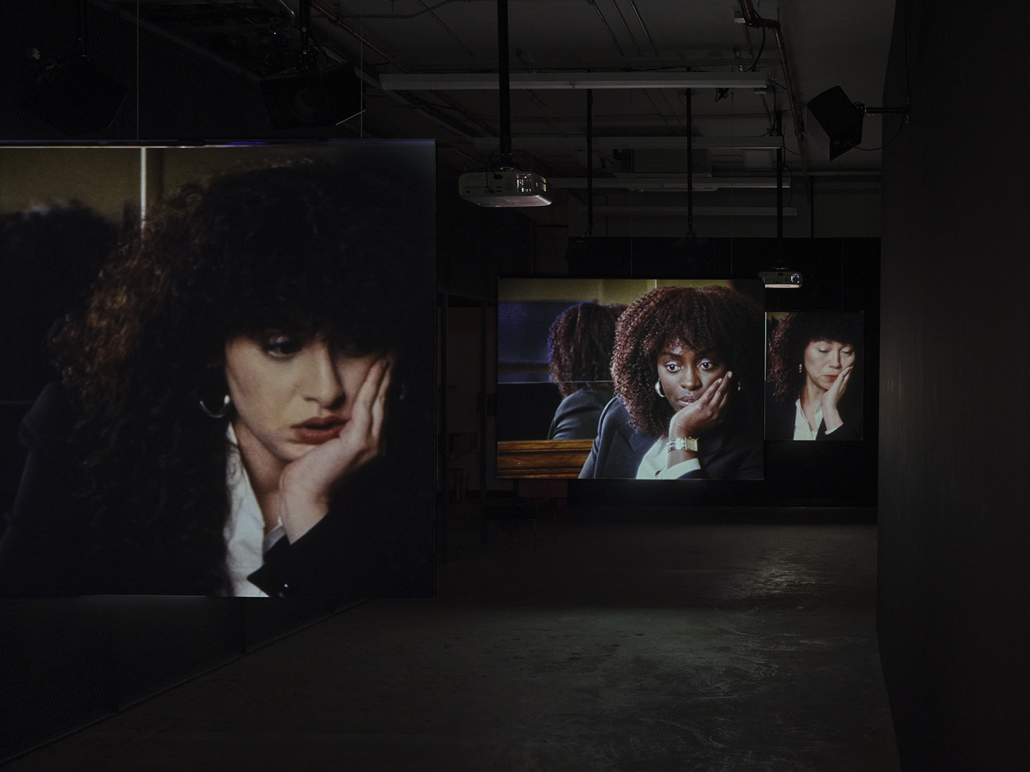 Elisabeth Subrin, *The Listening Takes / Manal Issa, 2024*, 2024, installation view; pictured *The Listening Takes*, 2023-2024, <br>30:00 minutes, 3-channel 16mm/HD video, 9-channel sound, speakers, suspended screens, Photo: Daniel Kukla