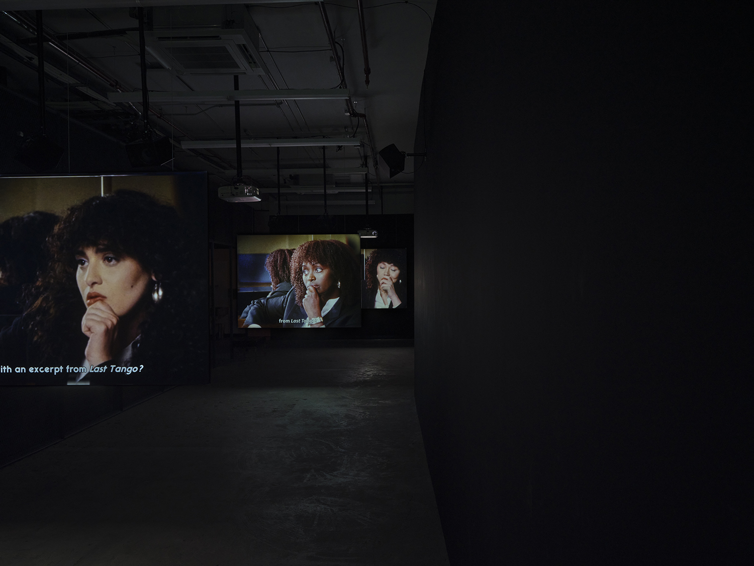 Elisabeth Subrin, *The Listening Takes / Manal Issa, 2024*, 2024, installation view; pictured *The Listening Takes*, 2023-2024, <br>30:00 minutes, 3-channel 16mm/HD video, 9-channel sound, speakers, suspended screens, Photo: Daniel Kukla