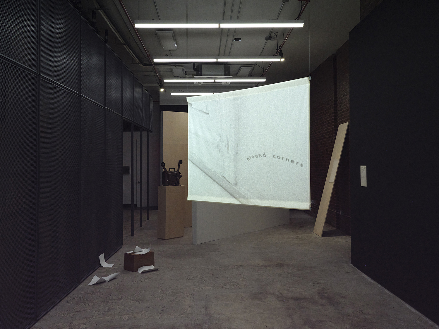 Jimmy Robert, *Untitled*, 2005, A4-sized painted aluminum sheets and cardboard box, dimensions variable. Collection of Hugo Brown, Jimmy Robert, <br>*Object/My affection*, Super-8 transferred to 16mm, black & white, silent, 3:00 minutes. Sheetrock and plywood walls, dimensions variable. <br>Performed by Raymond Pinto, Theresa Hak Kyung Cha, *Translations from a Willow Tree,* 1976, Super 8 transferred to digital video, black & white, <br>silent, 4:00 minutes, Jimmy Robert, *Untitled*, 2009, masking tape on paper with tracing paper pinned to plywood plank, paper, plank and Theresa Hak Kyung Cha, <br>*Untitled (august/september 1976)*, 1976, original: typewritten text on paper, exhibition copy: pigment print on hemp and mulberry paper fiber, Photo: Daniel Kukla