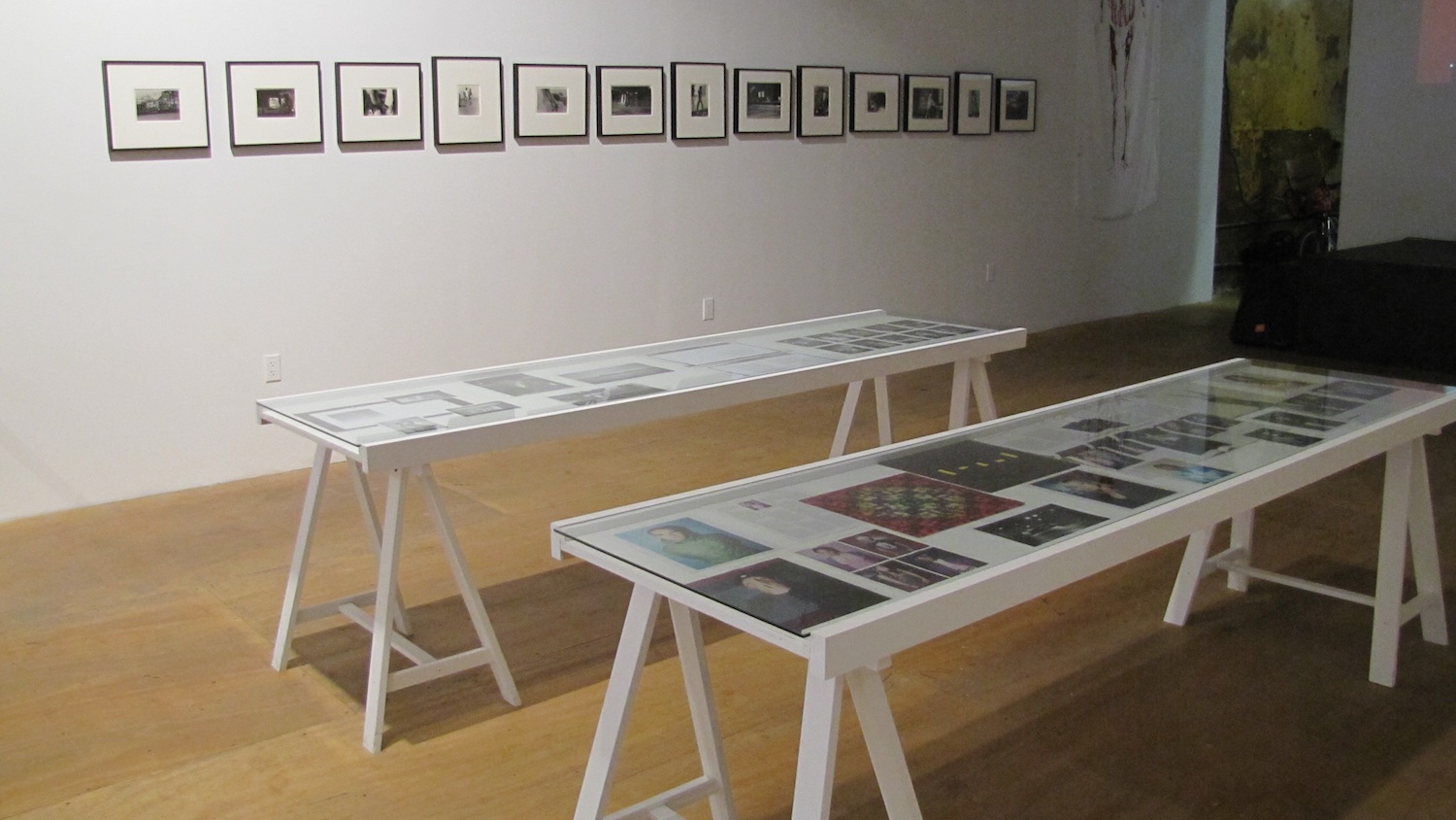 *Dead Flowers,* Installation View. George Gatsas, *Signal the Future*, 2010, Table collage, 2 tables with paper objects. Alvin Baltrop, *Untitled (from the series “Pier Photographs”)*, 1975-1986, 13 silver-gelatin prints, various dimensions. Courtesy The Alvin Baltrop Trust