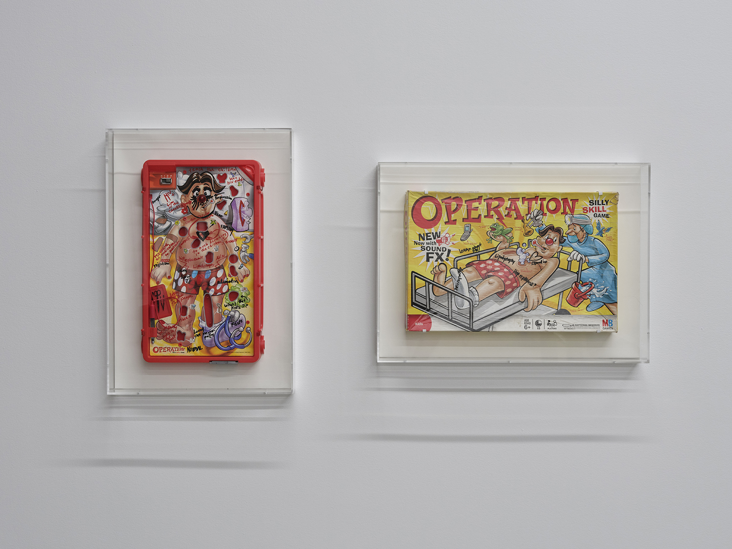 Chloe Dzublio, *The Prince George Drawings*, curated by Alex Fleming and Nia Nottage, installation view at Participant Inc, NYC, pictured (right to left): *Operation Game (box)*, c. 2010, black ink on found game set, and *Operation Game*, c. 2010, black ink on found game set, Photos by Studio Kukla  