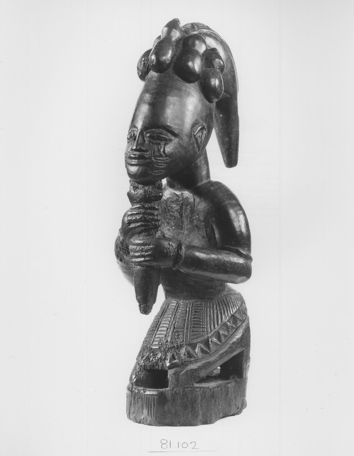 Kneeling Figure (Eshu-Elegba). Height: 11 in. (28 cm). Yoruba. Late 19th, early 20th century. 

Photographic reproduction. Brooklyn Museum. Arts of Africa Collection. Gift of Dr. and Mrs. Joel Hoffman. Copyright: Creative Commons Attribution 3.0. 

[Image description: A photographic reproduction of a carved sculpture of a kneeling figure, Legba, the god of the crossroads, as well as the god of chaos; depicted here as a figure who serves as a connecting tissue between Africans on the continent and the Diaspora.]