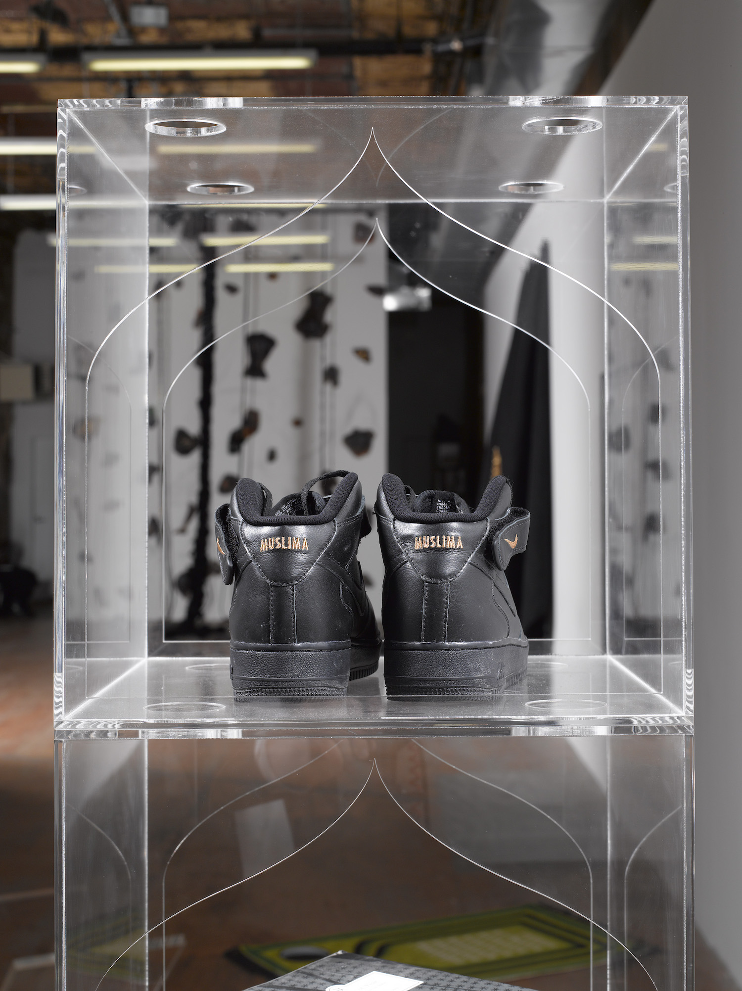 Baseera Khan, *iamuslima*, 2017. Nike ID Tag customized Nike Air Force One Mid top shoes. *Shoe Racks*, 2017. Clear acrylic customized shelving. Photo: Thomas Barratt and Mark Waldhauser